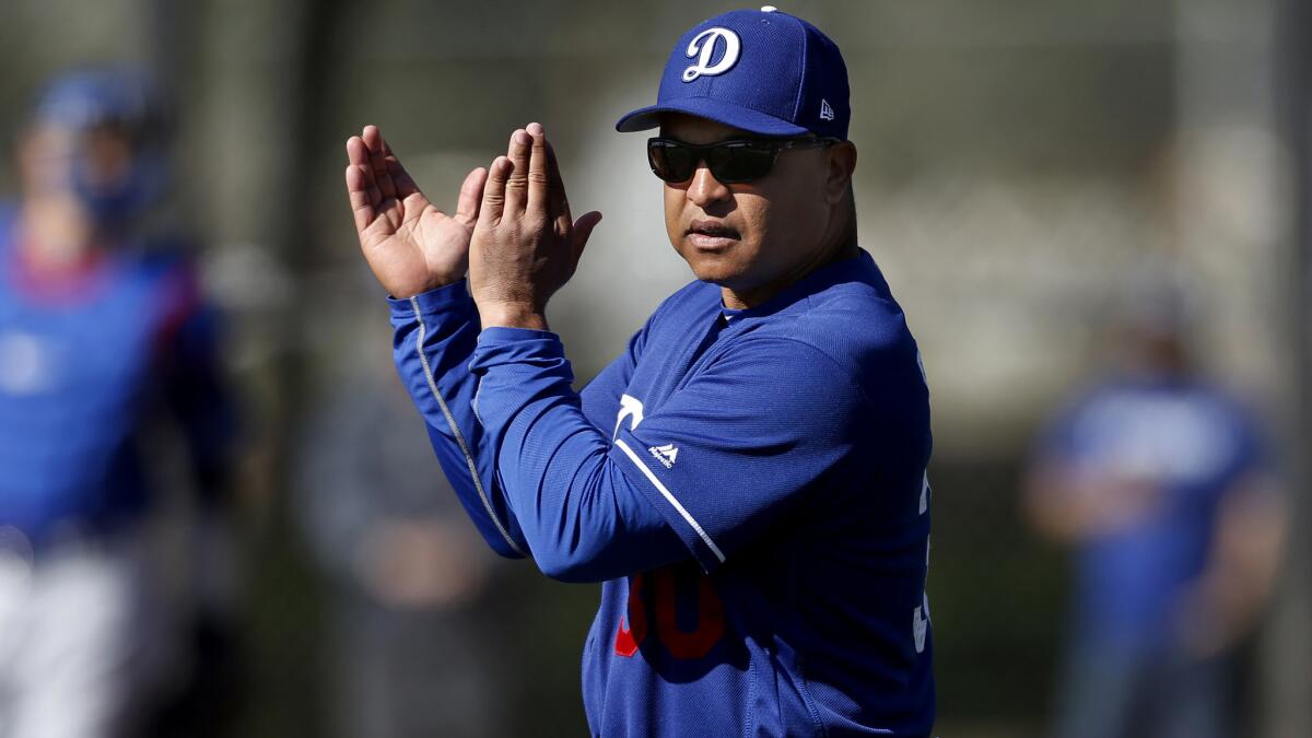 Dodgers Manager Dave Roberts takes his club go through a spring training workout last month at Camelback Ranch in Arizona.