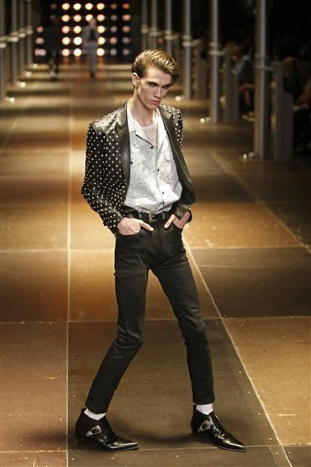 A model displays a creation as part of Yves Saint-Laurent Men