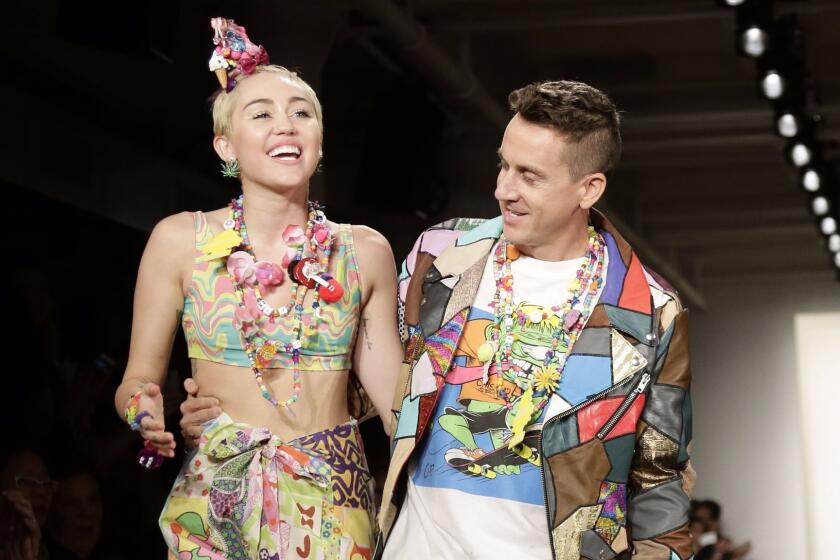 Mandatory Credit: Photo by Jason Szenes/Epa/REX/Shutterstock (7950578dk) Us Singer Miley Cyrus (l) Walks on the Runway with Us Designer Jeremy Scott (r) at the Conclusion of His Spring 2015 Collection During Mercedes-benz Fashion Week in New York New York Usa 10 September 2014 the Spring 2015 Collections Are Presented From 04 to 11 September United States New York Usa New York Fashion Week - Sep 2014