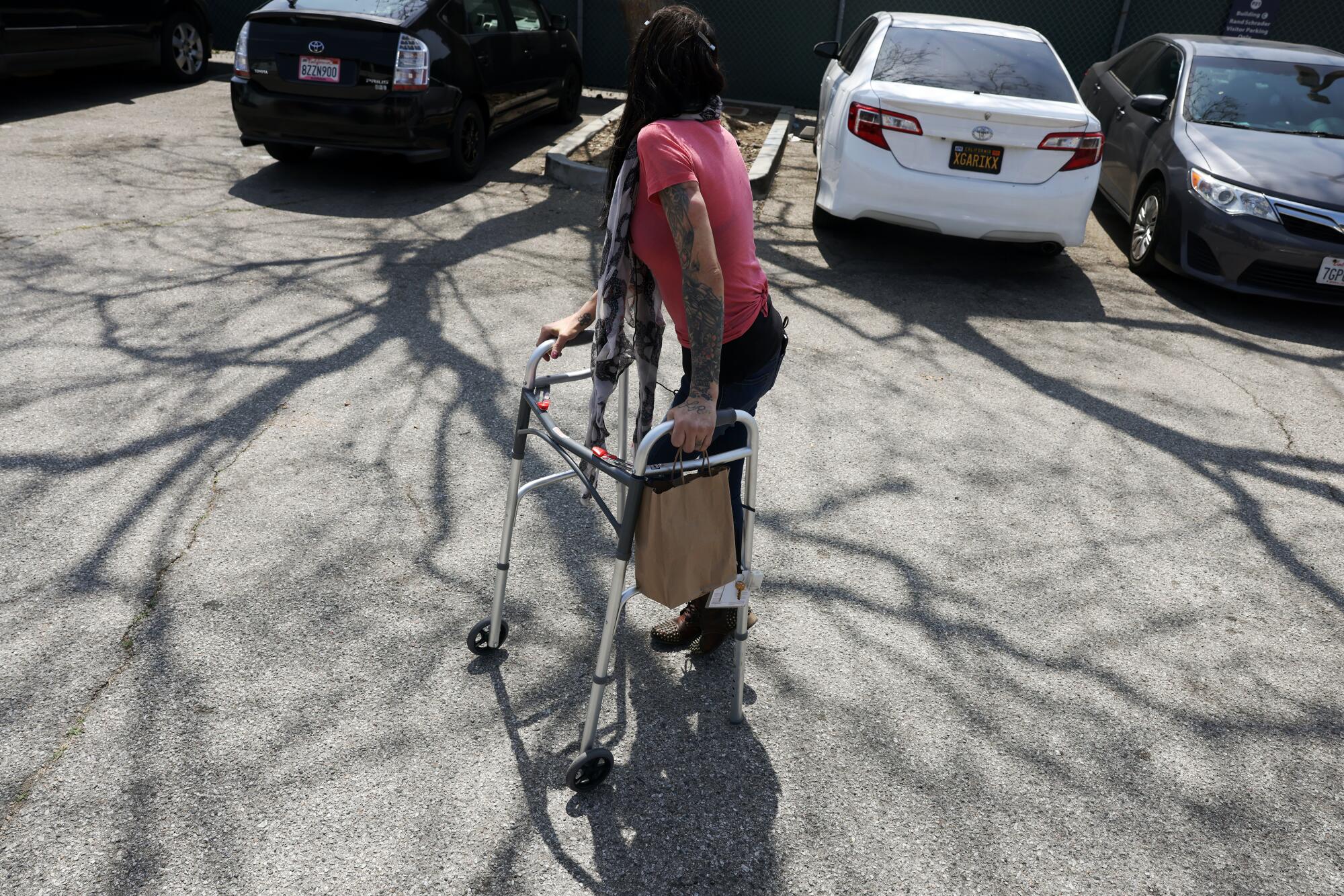 Loretta Elias walks out from the treatment center after taking a dose of methadone.