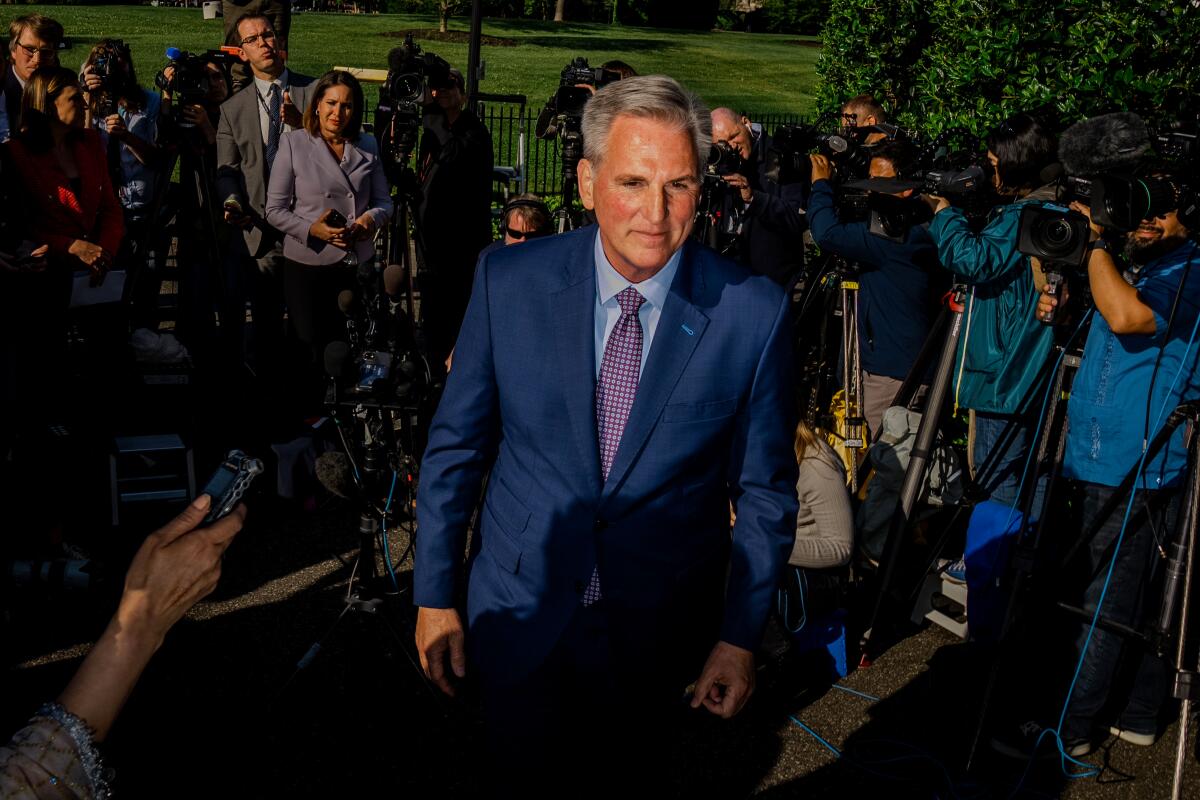 Kevin McCarthy standing outside, surrounded by members of the media