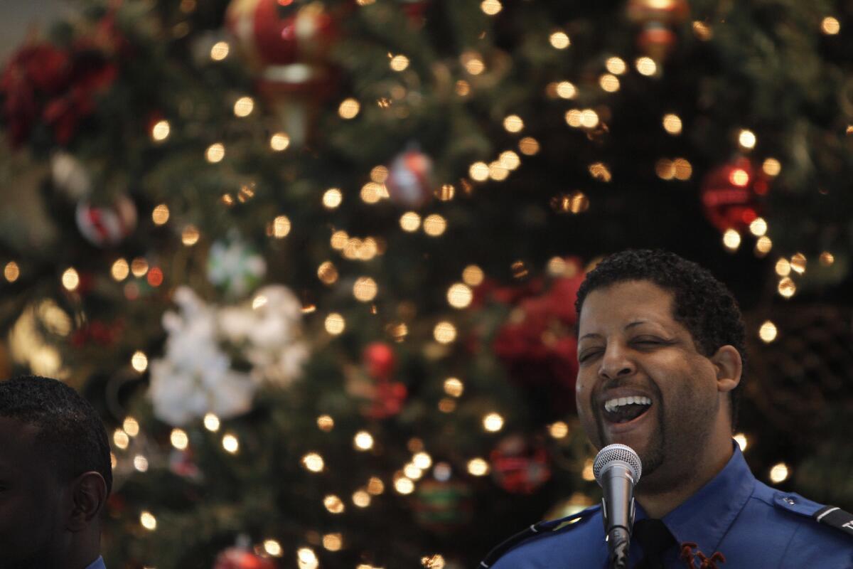 TSA agent Eric Monroe of the TSA Choir sings holiday songs at LAX in 2011.