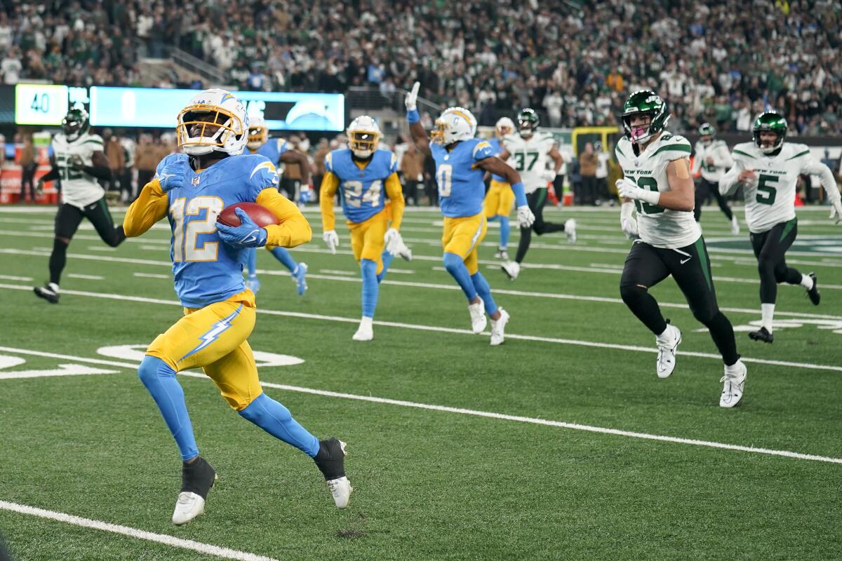 The Chargers' Derius Davis (12) returns a punt for a touchdown against the Jets.