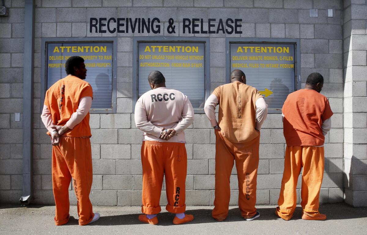 Prisoners from Sacramento County await processing after arriving at the California Department of Corrections and Rehabilitation Deuel Vocational Institution (DVI) in Tracy, Calif.