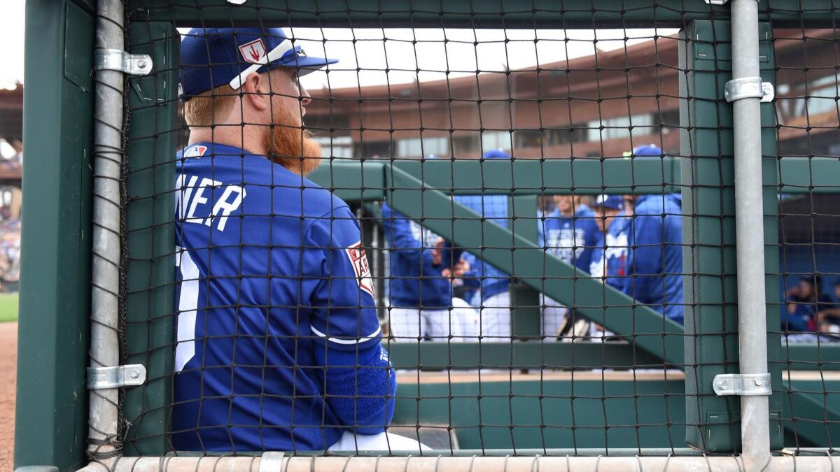 Justin Turner sits on the dugout steps prior to a spring training game against the San Francisco Giants at Camelback Ranch on March 11.