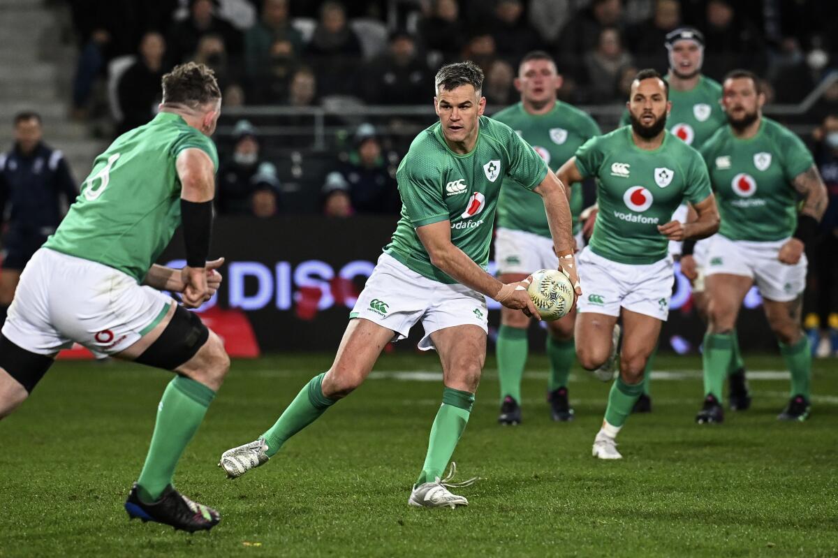 FILE - Ireland captain Johnny Sexton, center, passes the ball during their second rugby union international match against New Zealand in Dunedin, New Zealand, Saturday, July 9, 2022. The 2023 Rugby Six Nations starts on Feb. 4. (Andrew Cornaga/Photosport via AP, file)
