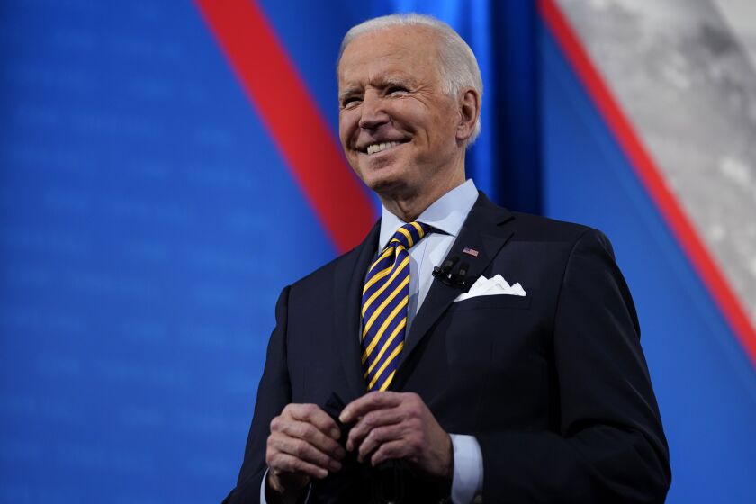 President Joe Biden stands on stage during a break in a televised town hall event at Pabst Theater, Tuesday, Feb. 16, 2021, in Milwaukee. (AP Photo/Evan Vucci)