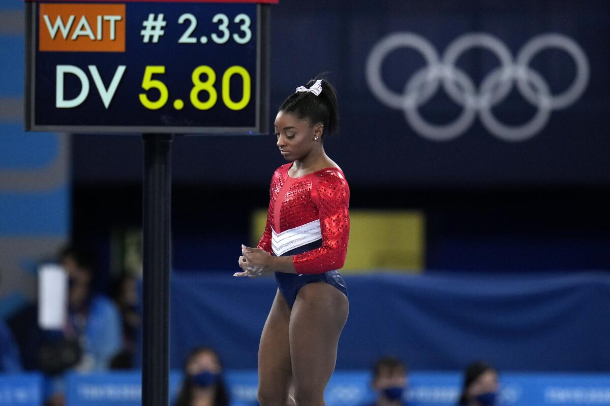 Simone Biles waits to perform on the vault during the gymnastics team final.