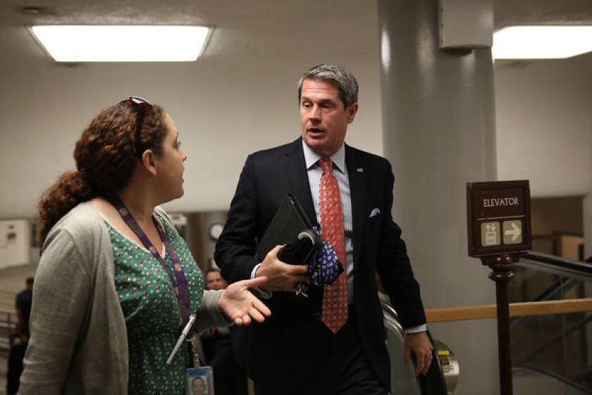 Sen. David Vitter (R-La.) speaks to members of the media prior to a vote on the Senate floor on Capitol Hill in Washington.