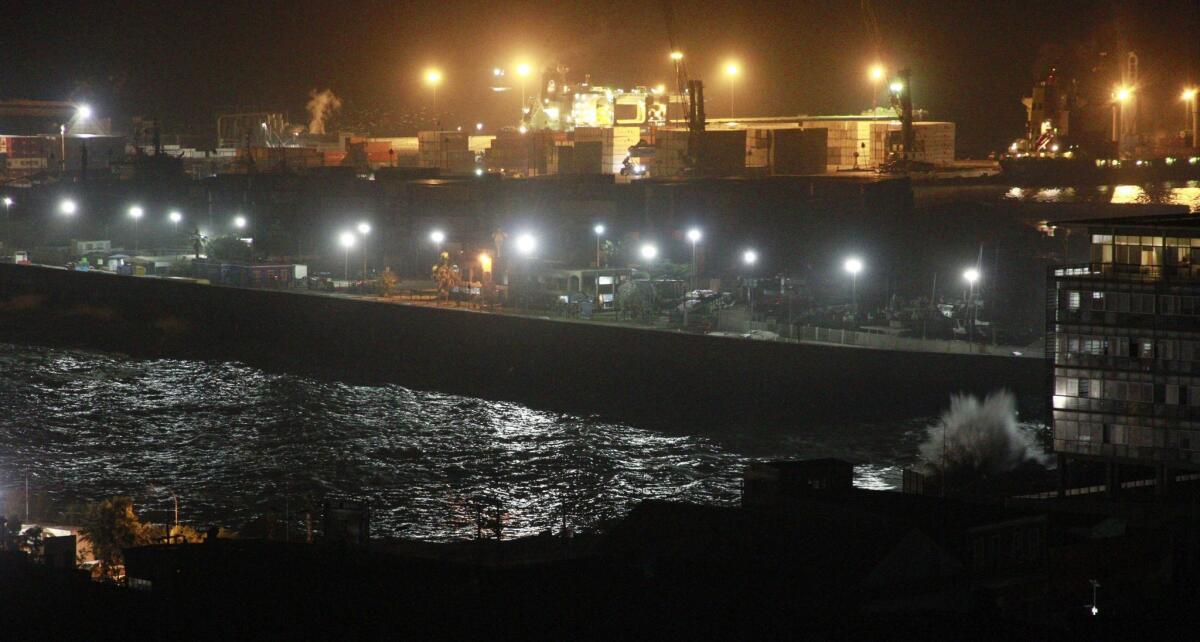 Waves crash into the port of Iquique, in northern Chile, after a powerful earthquake Tuesday.