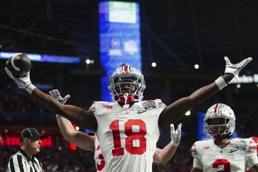 Ohio State wide receiver Marvin Harrison Jr. (18) celebrates hos touchdown catch against Georgia during the first half of the Peach Bowl NCAA college football semifinal playoff game, Saturday, Dec. 31, 2022, in Atlanta. (AP Photo/John Bazemore)