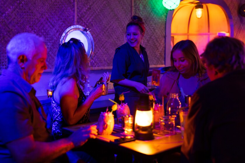 Acey-Doucey Club visitors choose tiki drinks and food "rations" at the Horton Grand Hotel.