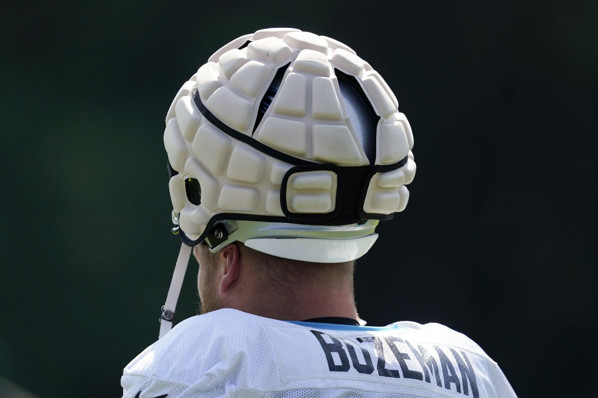 Carolina Panthers' Bradley Bozeman arrives for the NFL football team's training camp wearing his helmet with a protective covering at Wofford College on Tuesday, Aug. 2, 2022, in Spartanburg, S.C. The NFL has made the use of Guardian Caps mandatory up until the second week of the preseason for offensive and defensive lineman, linebackers and tight ends. (AP Photo/Chris Carlson)