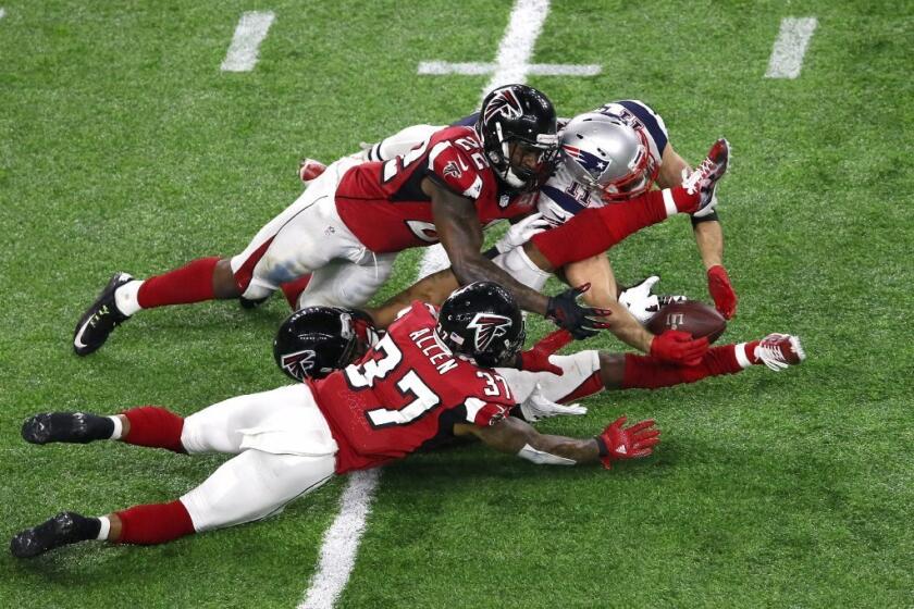 Patriots receiver Julian Edelman (11) makes a 23-yard catch in the fourth quarter between Falcons defensive backs Ricardo Allen (37), Robert Alford (23) and Keanu Neal (22) in Super Bowl 51 on Feb. 5.