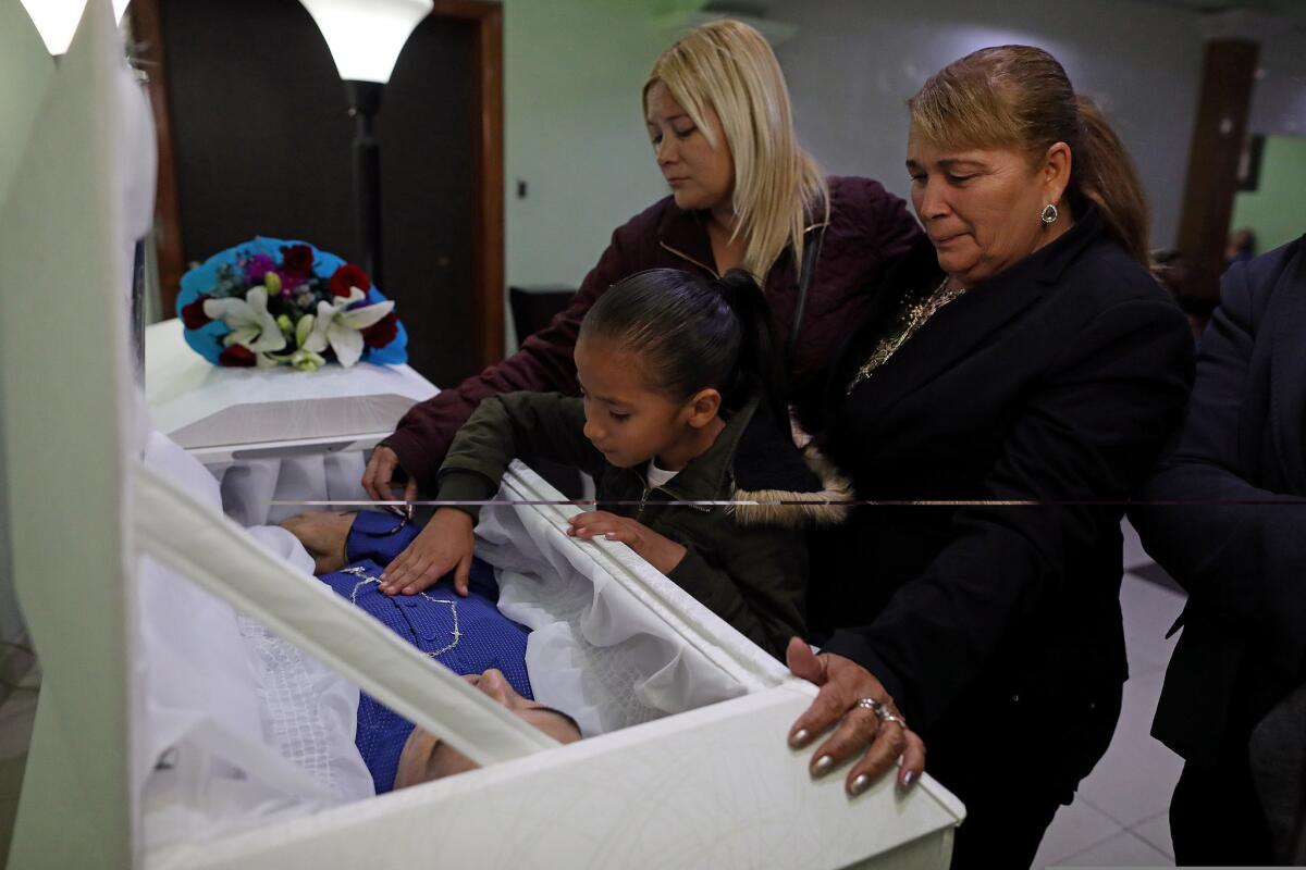 Bertha Peña, 59, right, with daughter Dulce Noriega, left, weeps for son Rafael Noriega Peña, 40, at Funeraria Martinez in Tijuana. Rafael, a father of five, was found dead in his room off the back of his mother's house with five gunshot wounds.
