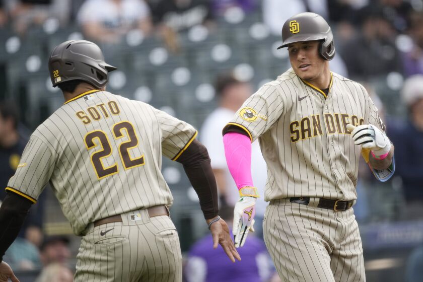 San Diego Padres' Juan Soto, left, congratulates Manny Machado after his two-run home run off Colorado Rockies starting pitcher Austin Gomber in the first inning of a baseball game Friday, June 9, 2023, in Denver. (AP Photo/David Zalubowski)