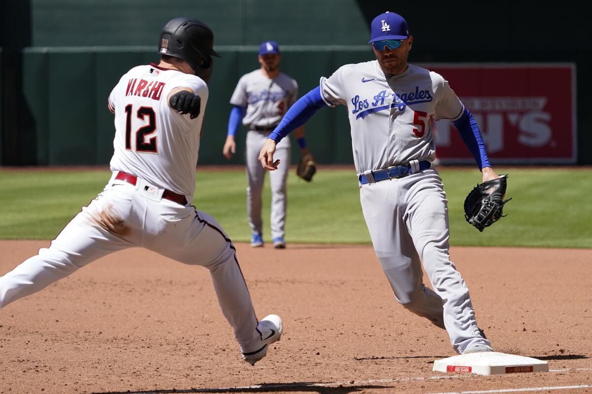 Dodgers' Freddie Freeman beats Arizona Diamondbacks' Daulton Varsho to first base for the out.