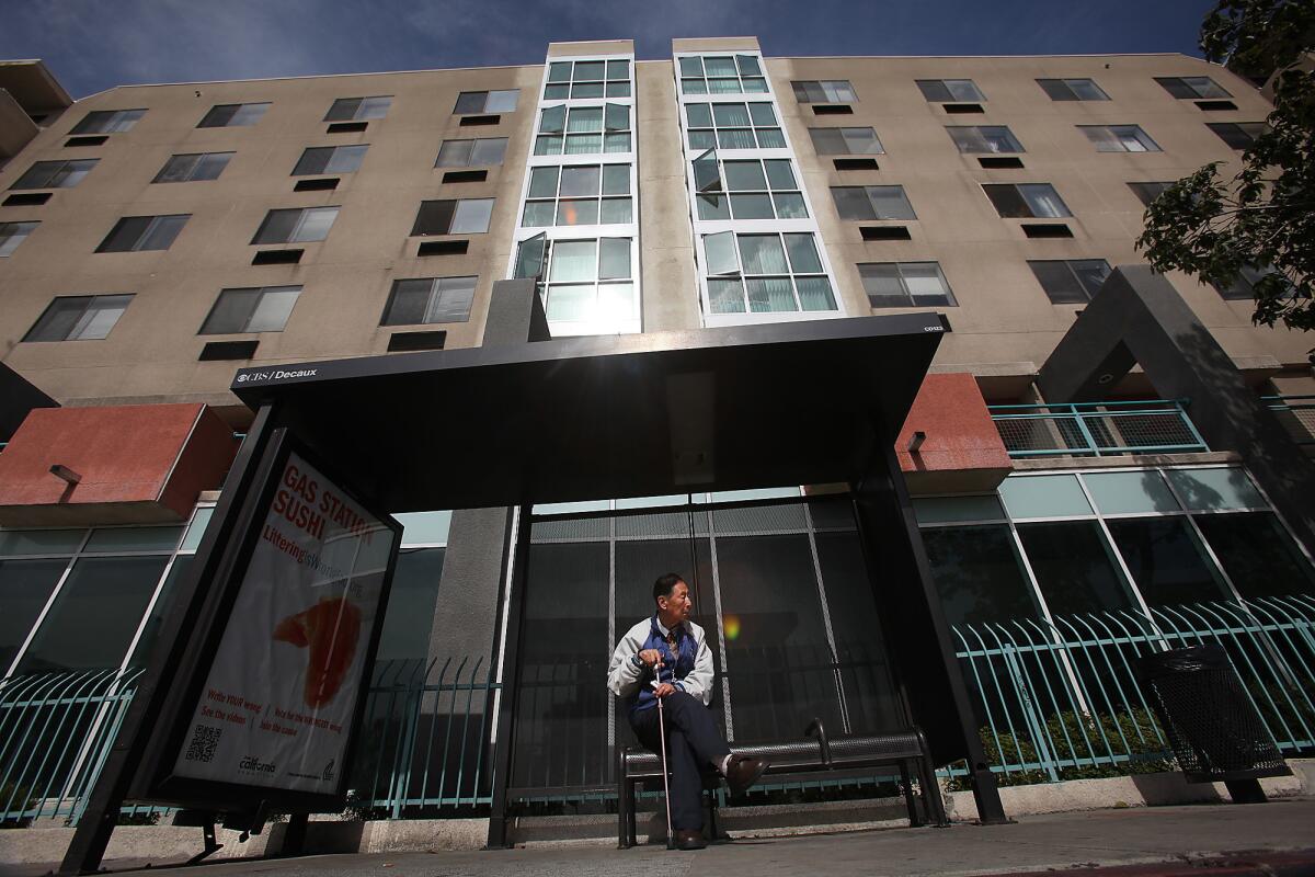 Wal-Mart plans to open a market in this multistory apartment building at Cesar Chavez and Grand avenues, but opponents are fighting it.