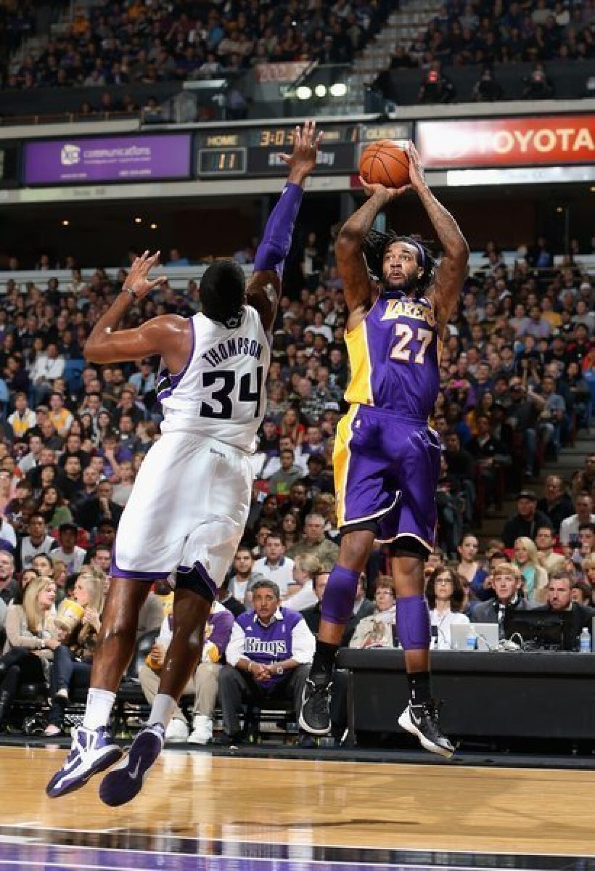 The Lakers' Jordan Hill shoots over the Sacramento Kings' Jason Thompson.
