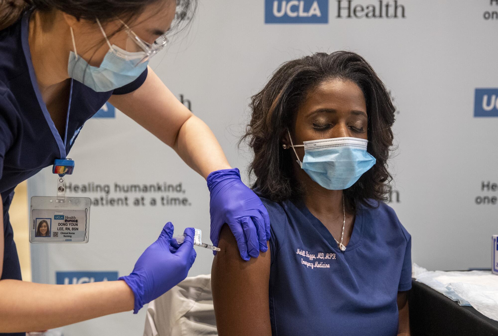 UCLA  Dr. Medell Briggs-Malonson gets an injection of the COVID-19 vaccine at Ronald Reagan UCLA Medical Center.