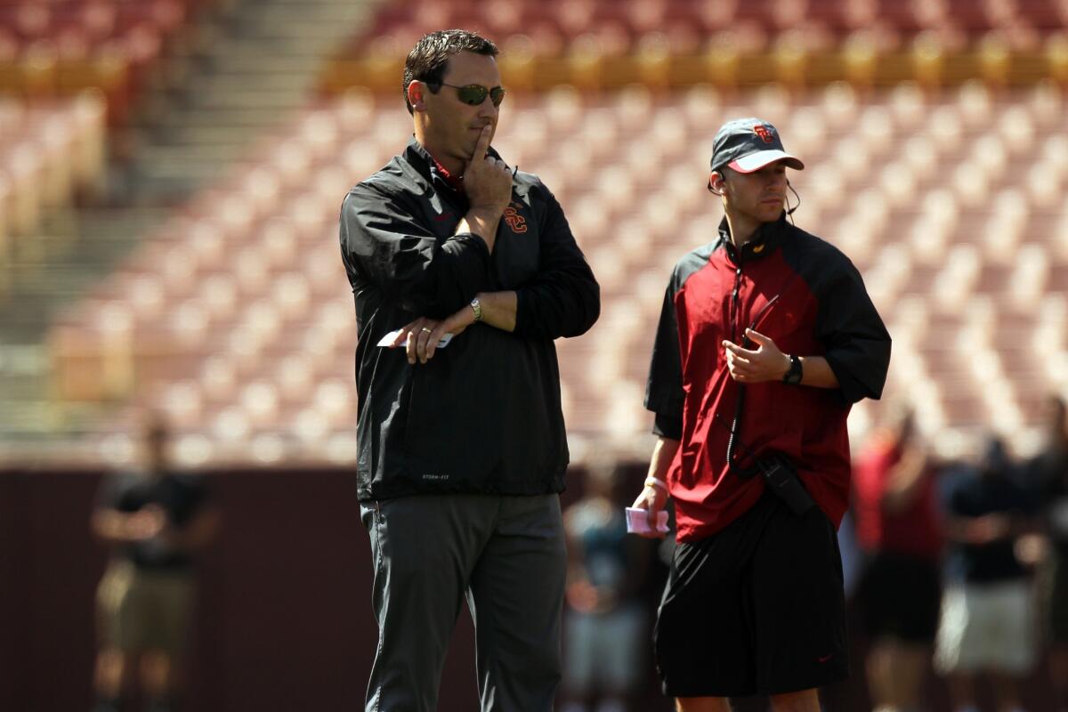 USC Coach Steve Sarkisian watches the Trojans' spring game at the Los Angeles Memorial Coliseum.