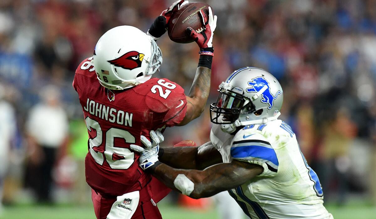 Cardinals safety Rashad Johnson intercepts a pass intended for Lions wide receiver Calvin Johnson in the third quarter Sunday at University of Phoenix.