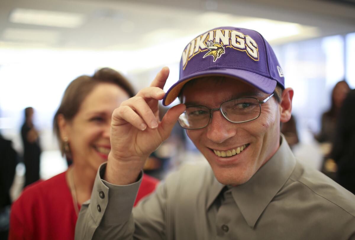 A Minnesota Vikings cap was one of the gifts Damon Thibodeaux received at a reception at Fredrikson & Byron to welcome him on Oct. 12, 2012, to Minneapolis. Thibodeaux who escaped death row in Louisiana in 2012 after he was exonerated by DNA evidence for a murder he didn’t commit has died of COVID-19 on Sept. 2, 2021. The 47-year-Thibodeaux, who eventually settled with his family in Texas, contracted the coronavirus in August, a few days after getting his first vaccine shot. (Jeff Wheeler/Star Tribune via AP)