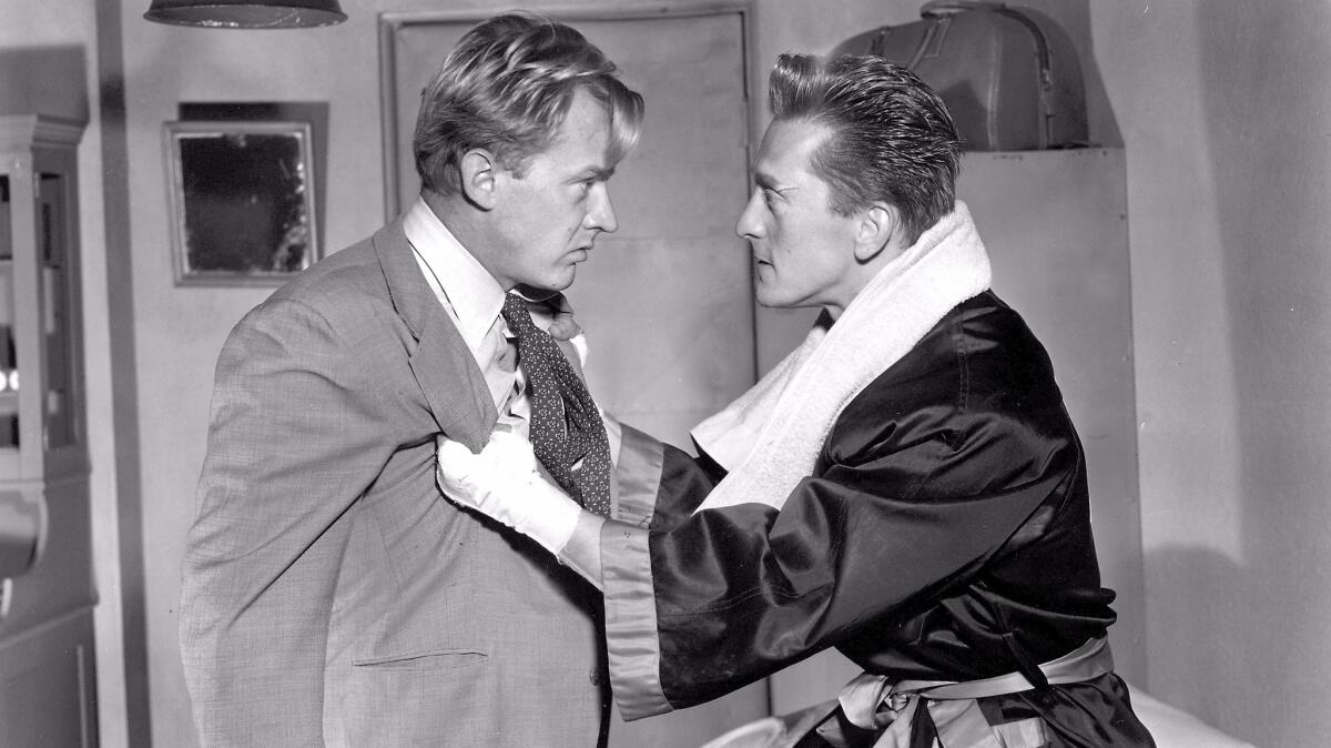 Kirk Douglas, right, as Midge Kelly, with Arthur Kennedy, in "Champion." (United Artists)