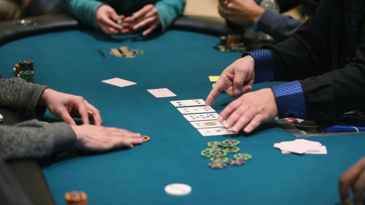 Participants play their hands at a poker event in Hollywood, Fla., in 2014.