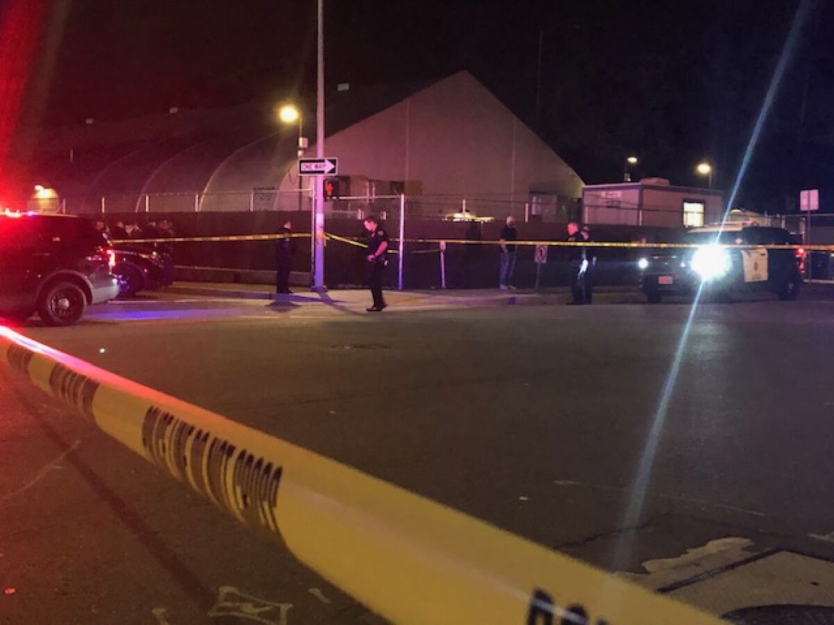 San Diego police cordoned off the street after a security guard was fatally shot Saturday night at the Alpha Project's winter shelter for the homeless at 17th Street and Imperial Avenue in East Village.