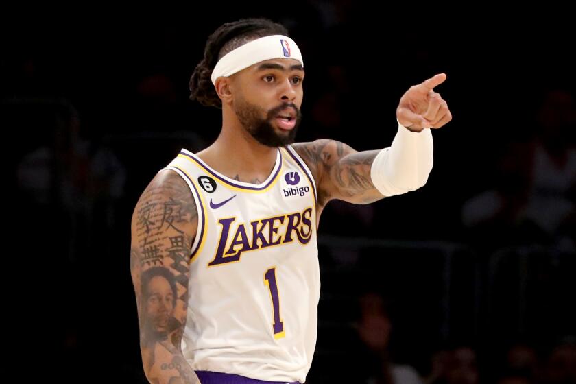Lakers guard D'Angelo Russell, left, celebrates a three-pointer against the Jazz on April 9, 2023, at Crypto.com Arena.