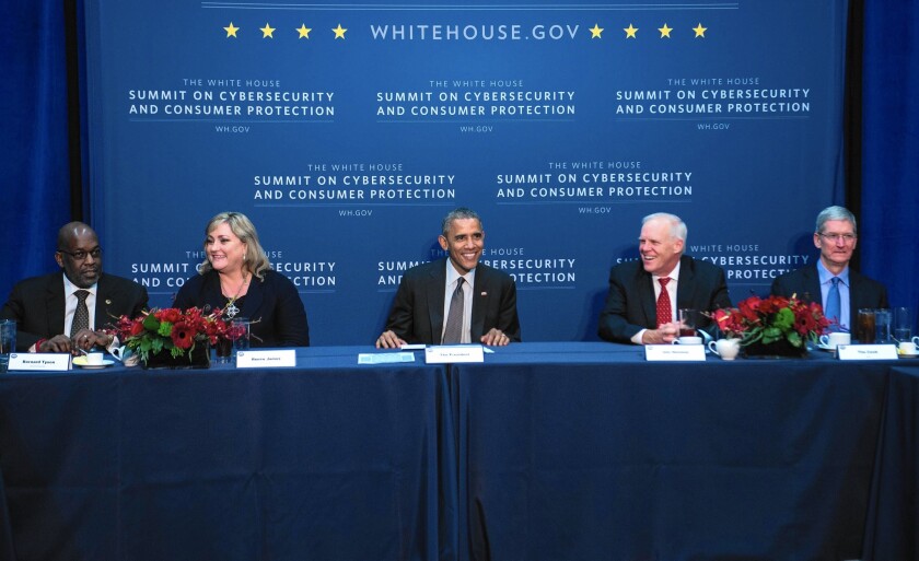 Stanford University President John L. Hennessy, second from right, takes part in a roundtable with President Obama and business leaders in February.