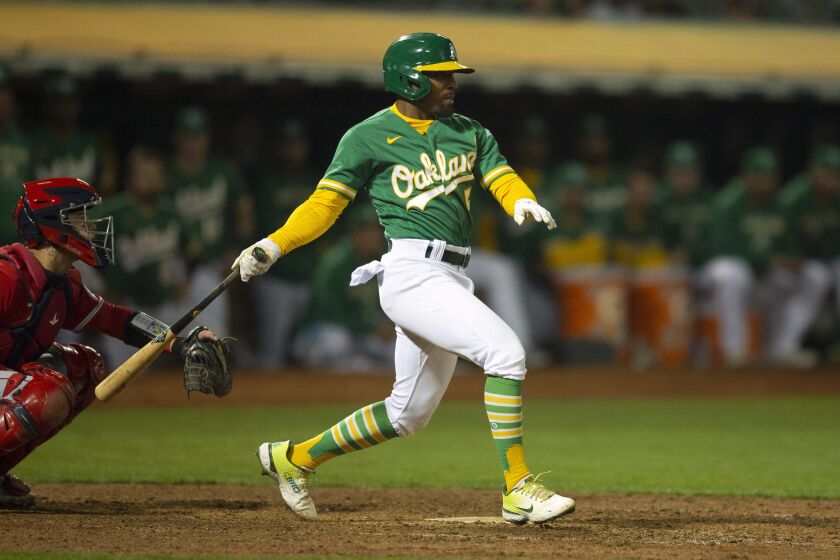 Oakland Athletics pinch hitter Tony Kemp (5) follows through on his game-winning single against the Los Angeles Angels during the tenth inning of a baseball game, Monday, Oct. 3, 2022, in Oakland, Calif. (AP Photo/D. Ross Cameron)