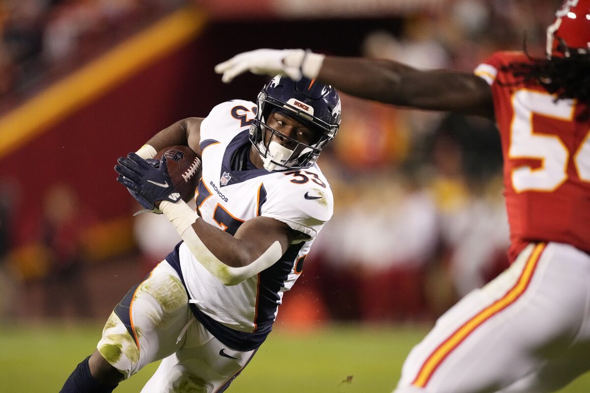 Denver Broncos running back Javonte Williams runs with the ball during the first half of an NFL football game against the Kansas City Chiefs Sunday, Dec. 5, 2021, in Kansas City, Mo. (AP Photo/Charlie Riedel)