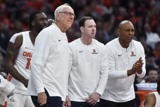 FILE -Syracuse head coach Jim Boeheim, left, assistant coach Gerry McNamara, center, and associate head coach Adrian Autry watch from the sideline during the second half of an NCAA college basketball game against Boston College in Syracuse, N.Y., Saturday, Dec. 31, 2022. Syracuse coach Jim Boeheim is retiring after 47 years of leading the university's basketball program, the team announced Wednesday, March 8, 2023 after a loss knocked them out of the ACC Conference Tournament. (AP Photo/Adrian Kraus)