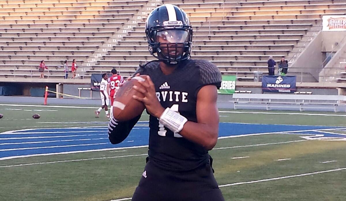 Servite quarterback Travis Waller warms up before the game against Mater Dei on Friday night.