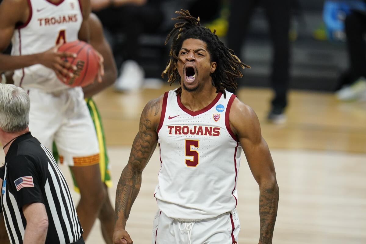 USC guard Isaiah White celebrates after making a basket against Oregon in the Sweet 16 of the NCAA tournament.