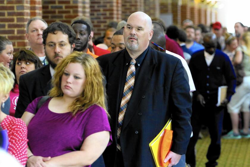 Job gains in May were mostly in the service sector, which accounted for 95% of the new jobs, according to ADP. Above, job seekers at a career fair in Georgia.