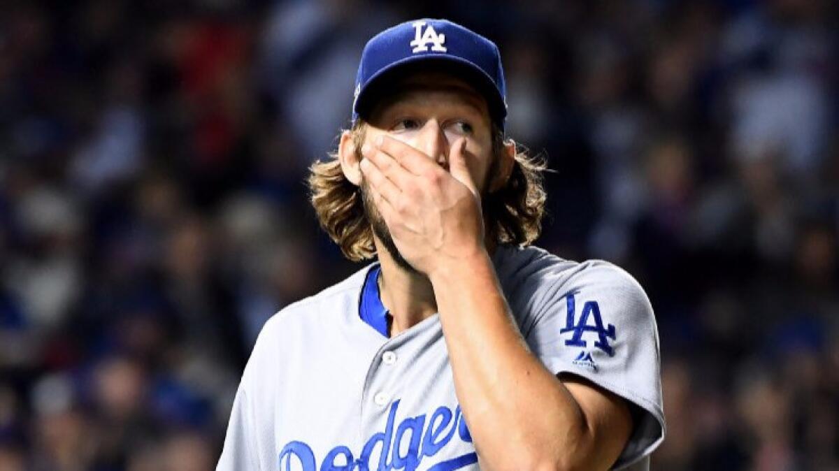 Dodgers pitcher Clayton Kershaw looks at the scoreboard as he walks back to the dugout after giving up a home run to Cubs Willson Contreras earlier in the fourth inning of Game 6.