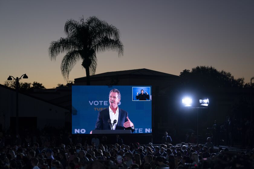 A large screen shows California Gov. Gavin Newsom as he speaks at a rally ahead of the California gubernatorial recall election Monday, Sept. 13, 2021, in Long Beach, Calif. (AP Photo/Jae C. Hong)