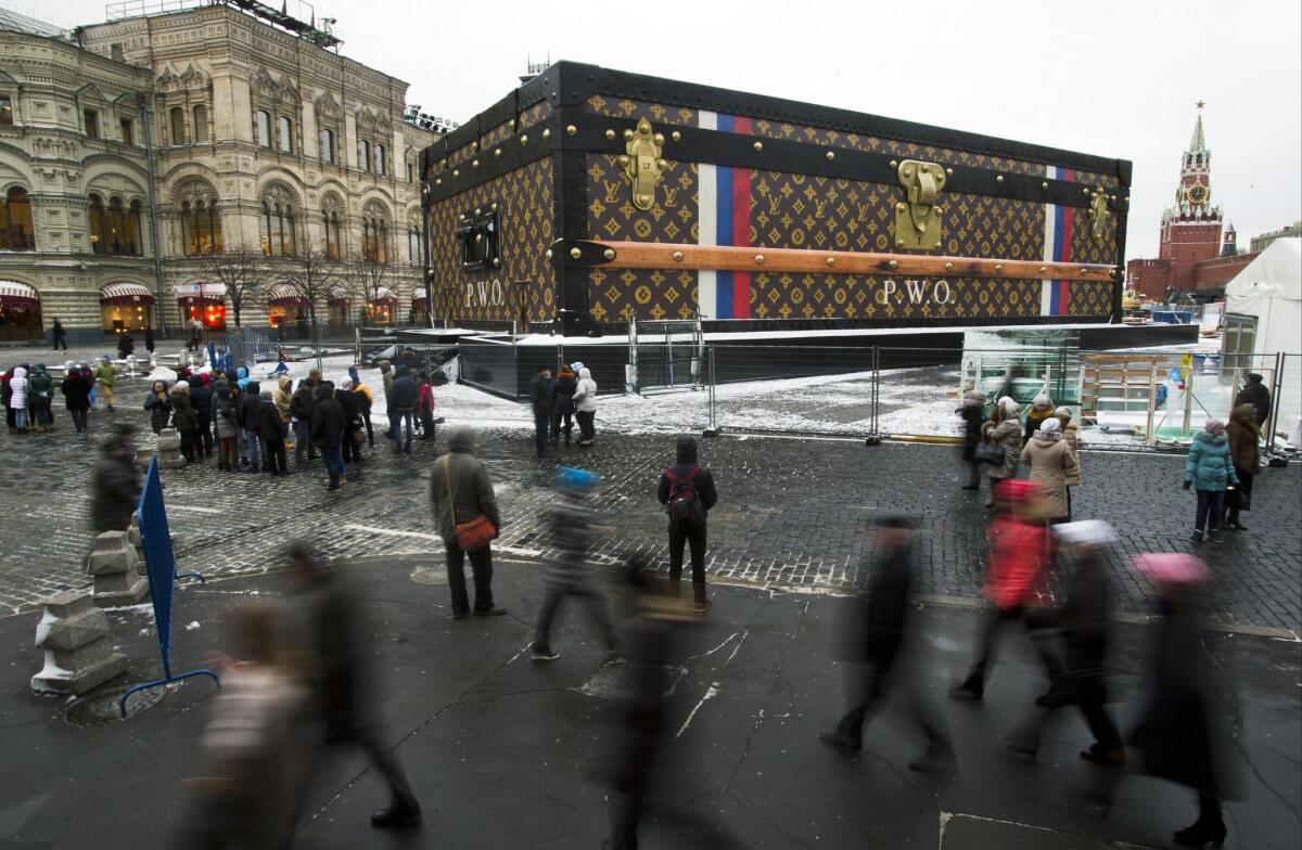 An exhibition hall in the shape of a giant Louis Vuitton trunk appeared at Red Square last weekend, intended to house a display by the French designer of famous travelers and their luggage. Muscovites objected to the commercial promotion in their hallowed central square, seen in this photo between the GUM department store and Spassky Tower, and its sponsors agreed Wednesday to remove it.