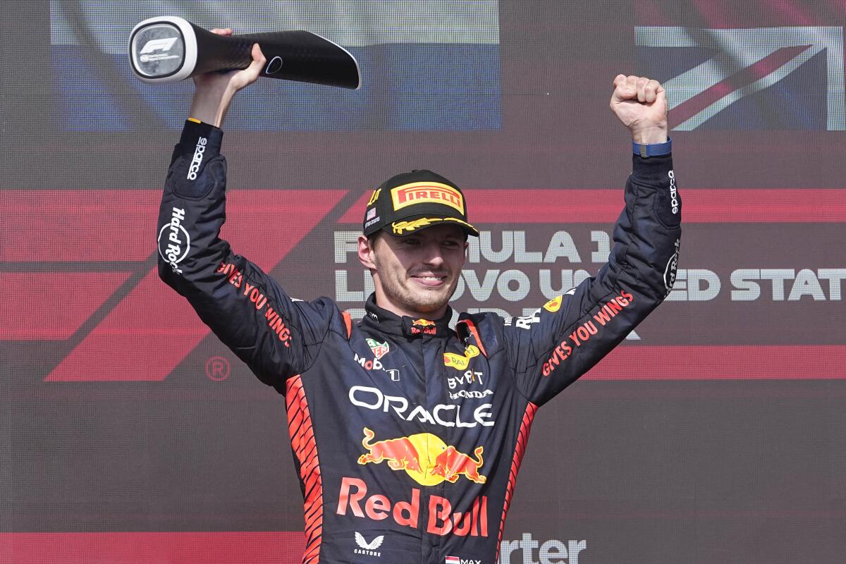 Red Bull driver Max Verstappen celebrates on the podium after winning the Formula One United States Grand Prix.