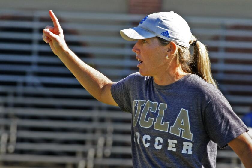 UCLA women's soccer Coach Amanda Cromwell gives instructions to the Bruins during a training session.