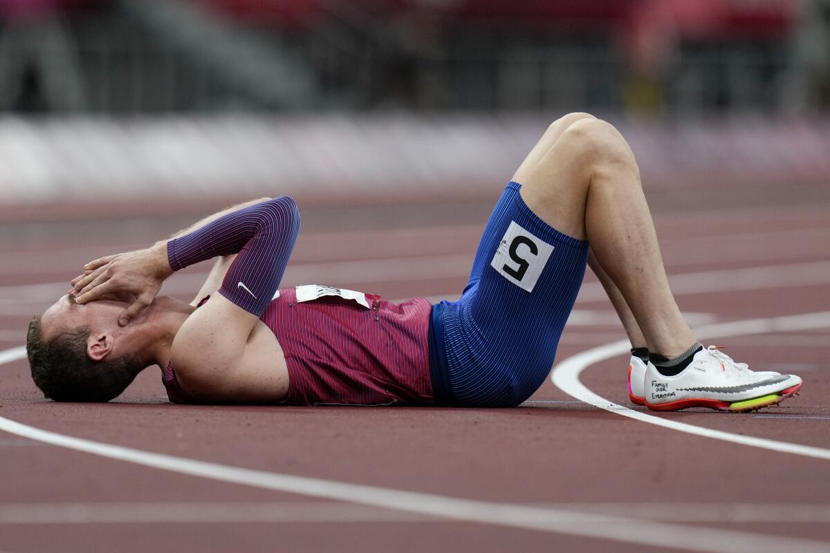 Disappointed U.S runner Clayton Murphy lies on the track with his hands over his face