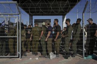 FILE - Israeli soldiers gather at the gate to the Sde Teiman military base, as people protest in support of soldiers being questioned for detainee abuse, July 29, 2024. (AP Photo/Tsafrir Abayov, File)