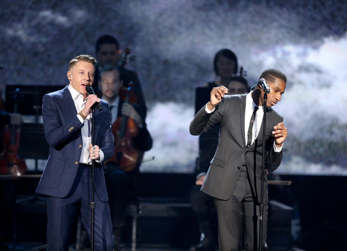 Macklemore, left, and Leon Bridges perform at the American Music Awards at the Microsoft Theater on Sunday.