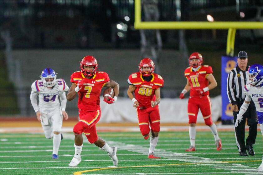 Running back Lucky Sutton of the Cathedral Catholic Dons runs for a touchdown in the Dons CIF State victory Friday Night. The Dons defeated the Folsom Bulldogs 33-21.