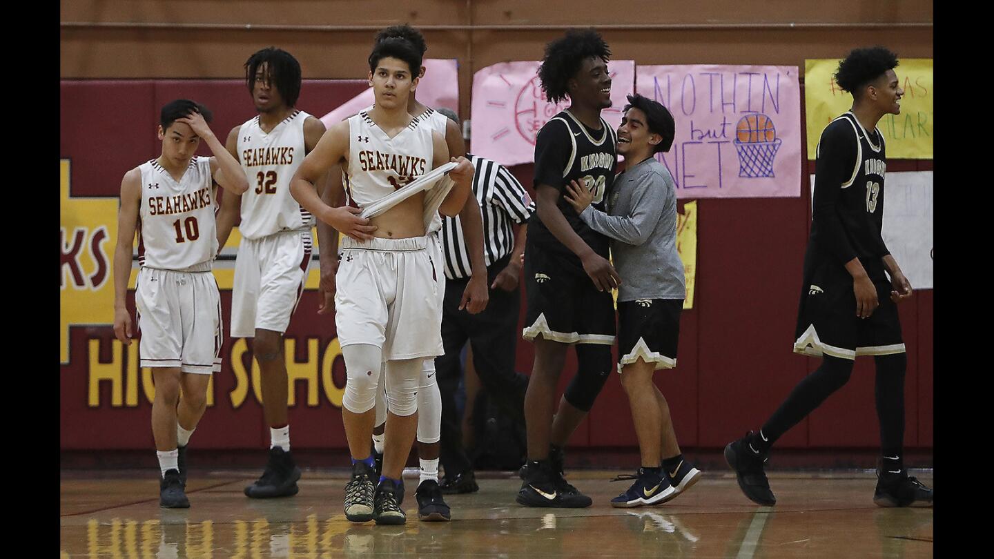Ocean View High boys' basketball players walk off the court after losing to Palmdale in a CIF Southern Section Division 3AA quarterfinal playoff game on Tuesday in Huntington Beach.