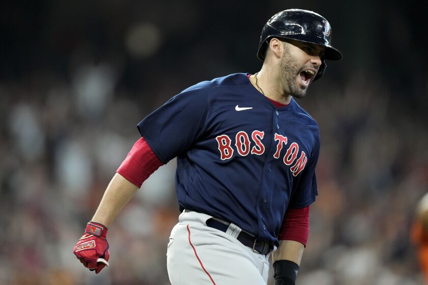 Boston Red Sox's J.D. Martinez celebrates his grand slam against the Houston Astros during the first inning in Game 2 of baseball's American League Championship Series Saturday, Oct. 16, 2021, in Houston. (AP Photo/David J. Phillip)