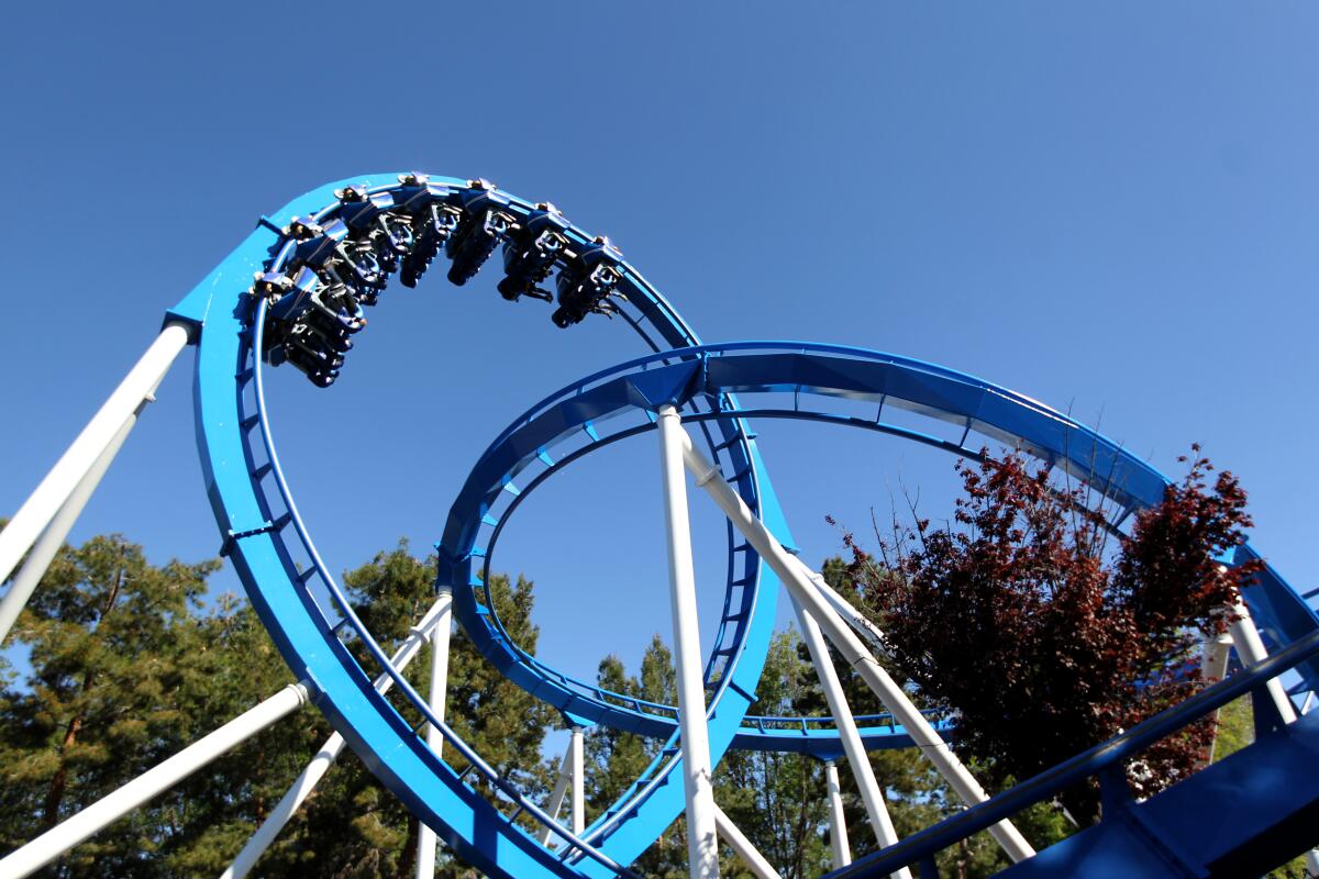 A view looking up at 360-degree loops in a roller coaster.